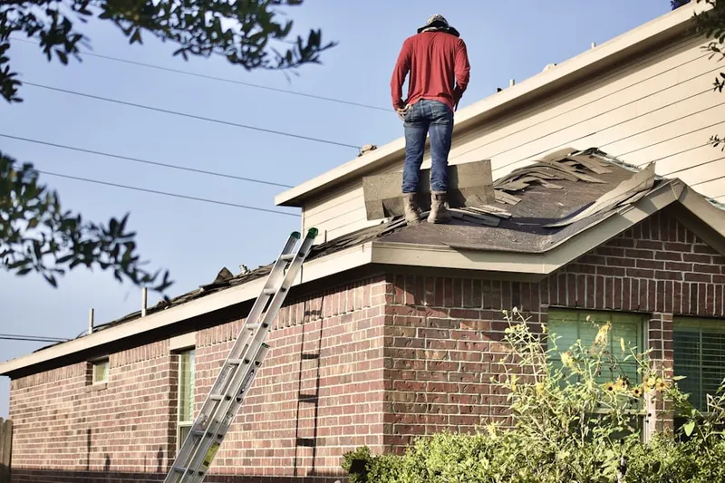 Professional roofer working on a residential roof in Milstead